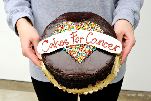 Cakes for Cancer founder Abigail Nathanon holding cake