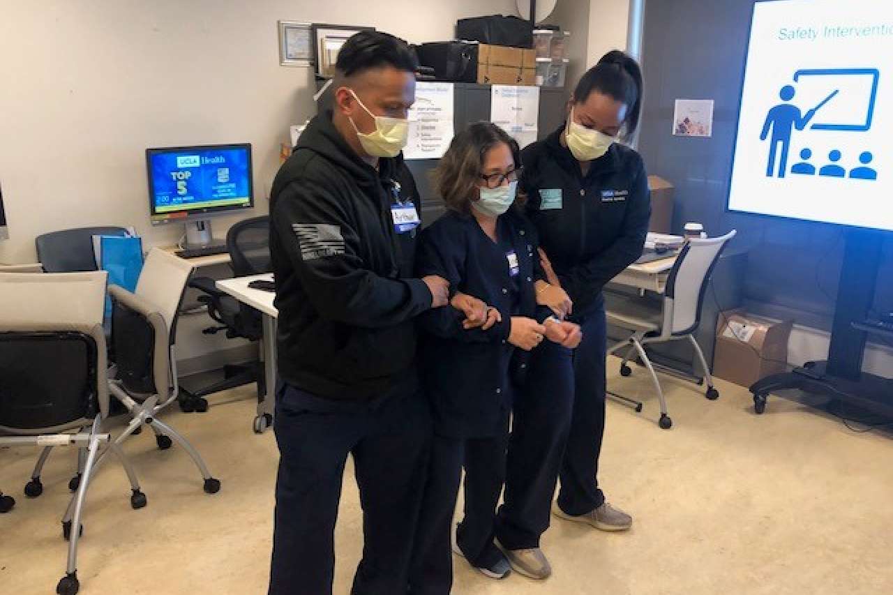 Nurses Arthur Tadiaman, left, Lisette Espana and Shoni Taylor practice Crisis Prevention & Intervention techniques, which are critical for their work at Resnick Neuropsychiatric Hospital.  