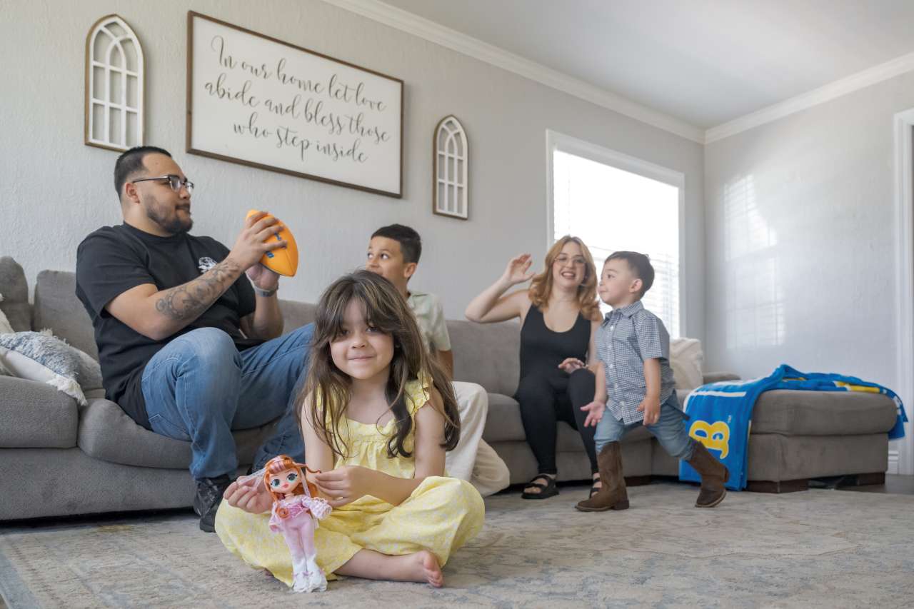 Raylee and her family in their living room, getting back to a normal life.