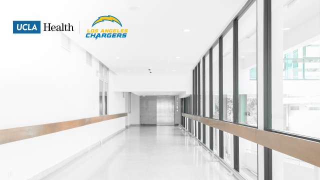UCLA Health and Los Angeles Chargers co-branded Zoom background featuring a bright hospital hallway with natural lighting.