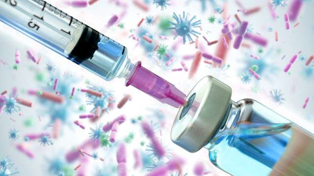 An illustration shows a vaccine in front of a background of cells.
