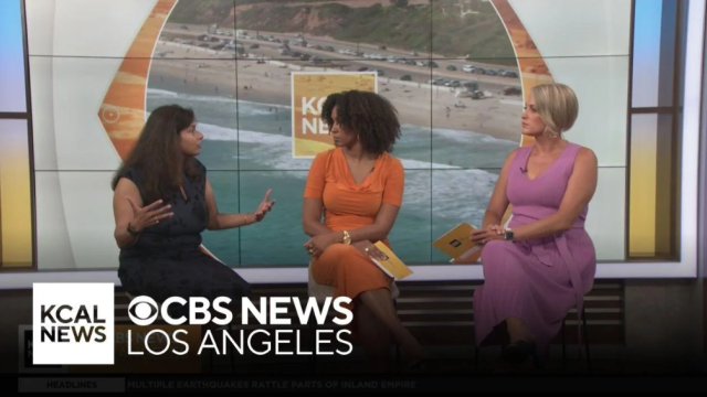 Dr. Vibha Singha being interviewed on stage by CBS anchors