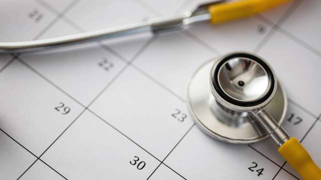 Closeup of a stethoscope resting on a calendar