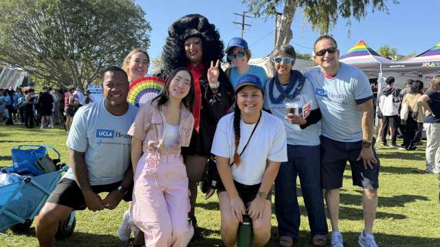 Group of people smiling at outdoor festival, one person wearing a gorilla costume