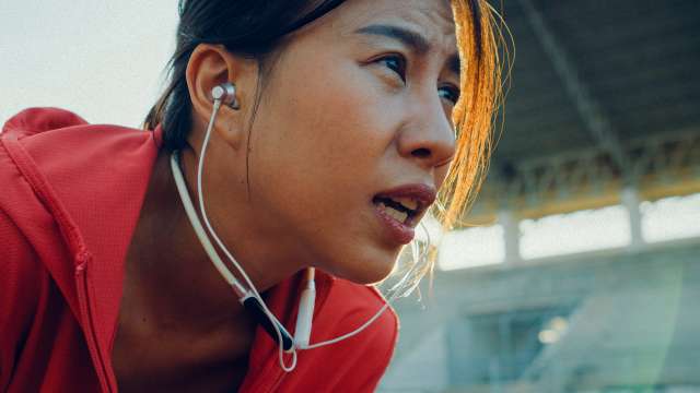 female runner with headphones