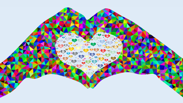 Prismatic hands full of colors forming the shape of a heart