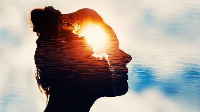 Silhouette of woman surrounded by water