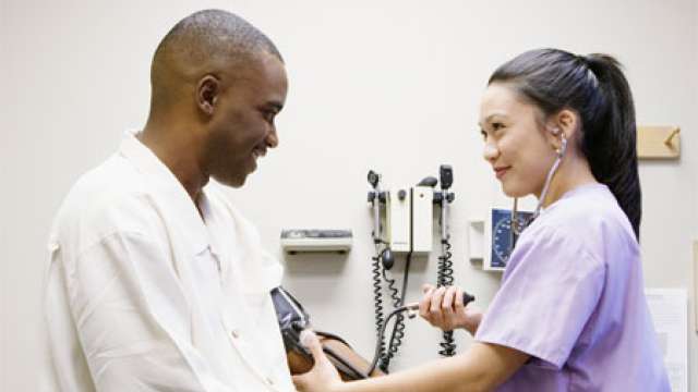 Nurse taking patient's blood pressure