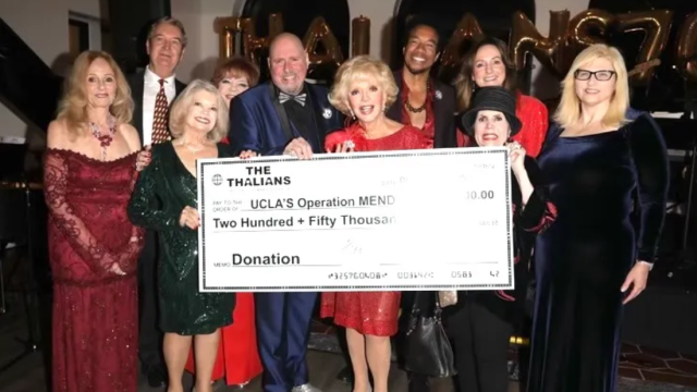 The Thalians holding a donation check for Operation Mend