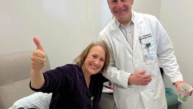 A happy patient with her doctor in a hospital room.