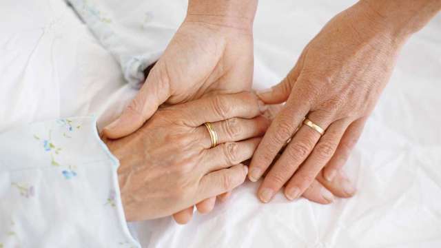 Holding patient's hand