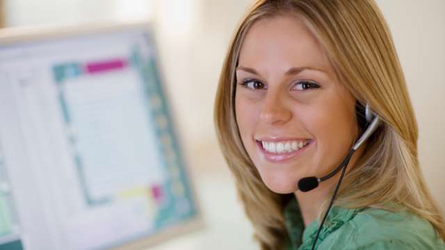Woman smiling wearing a headset
