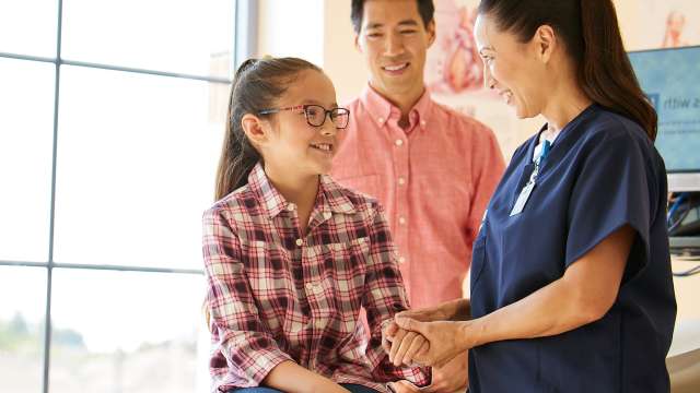 Nurse with pediatric patient and paren