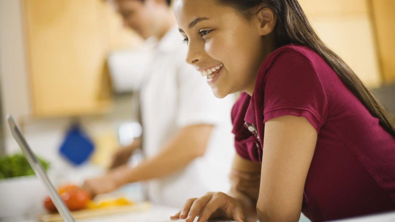 A tween girl using a laptop