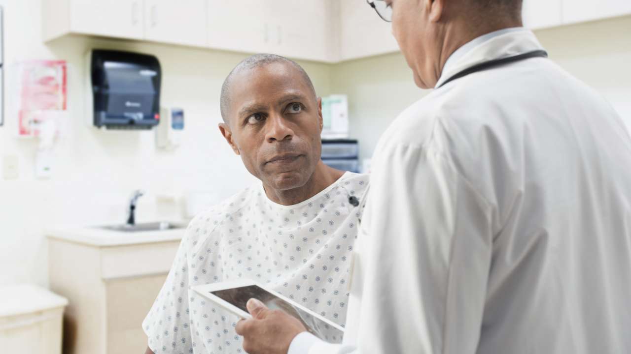 Worried patient listens to doctor.