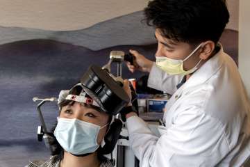 Electromagnets are placed in different locations on the head, depending on what region of the brain is being targeted. (Photo by Joshua Sudock/UCLA Health)