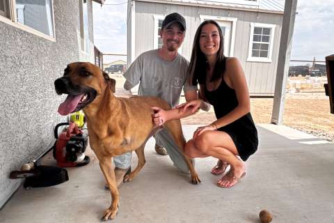 A man with an amputated arm, his wife, and a dog with an amputated leg.
