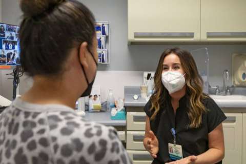 Rachel Frankenthal sitting in an office with a patient