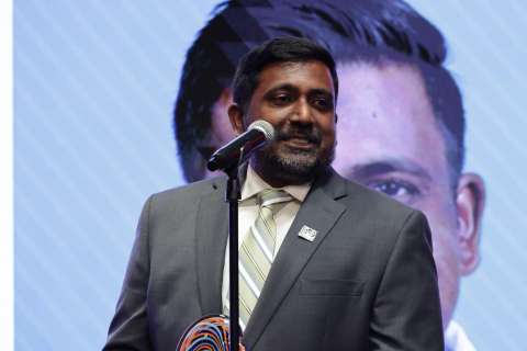 Dr. Raj Rajaraman speaks at a microphone after receiving the TSC Alliance's Champion Award in recognition of his care for Tuberous Sclerosis Complex patients.