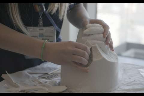 An ICU nurse making a hand mold keepsake