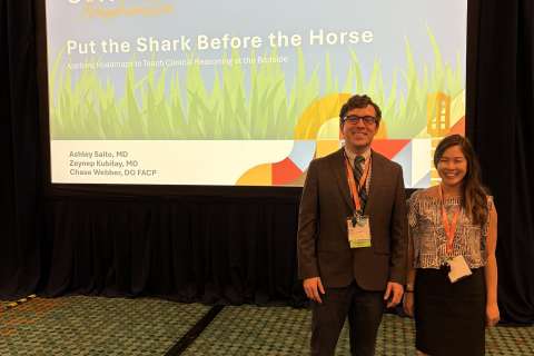 Two attendees by a Converge slide titled 'Put the Shark Before the Horse'