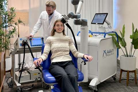 A patient receives transcranial magnetic stimulation (TMS) treatment.