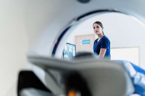Technician performing a CT scan