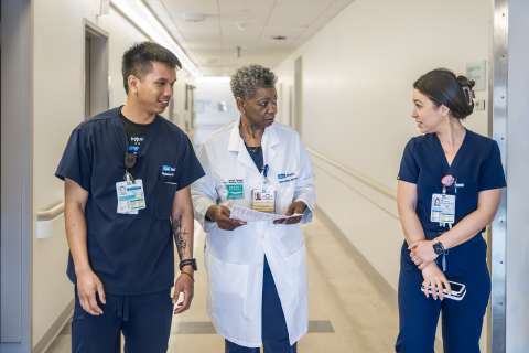 Unit director Grace Mayne remains accessible to her team, answering nurses’ questions as she moves between duties