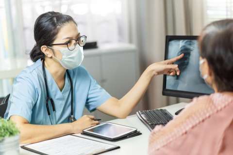 Doctor shows a scan to a lung cancer patient