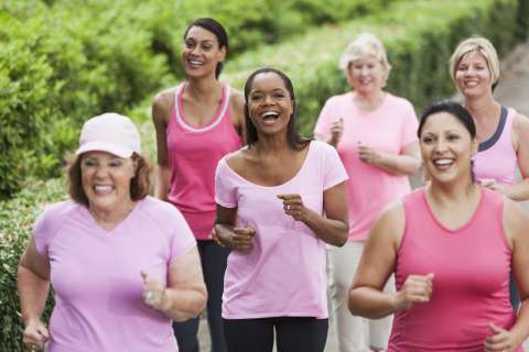 Breast cancer survivors running together outside