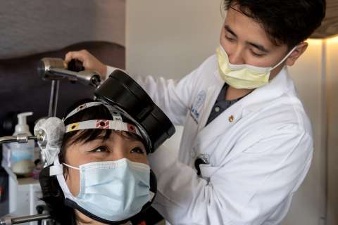 Patient being fitted with device