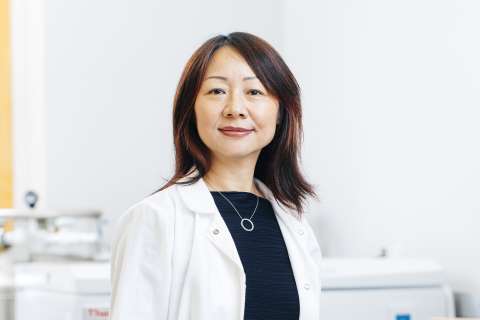 Dr. Lili Yang smiles for a headshot in the lab.
