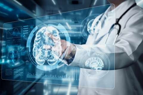 Medical professional interacting with a holographic brain scan display.