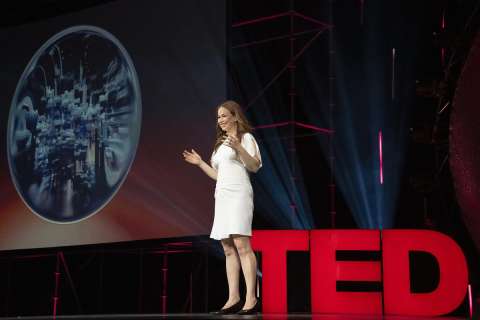 A speaker presents on stage.