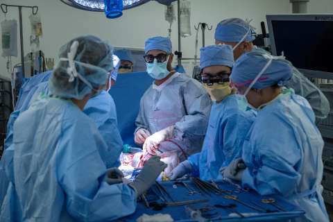 Surgeons perform a bladder transplant in an operating room.