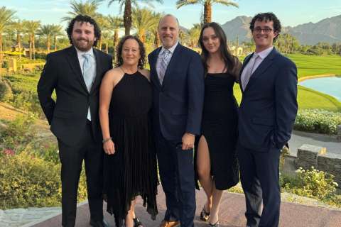 Ellen Pollack stands with her family.