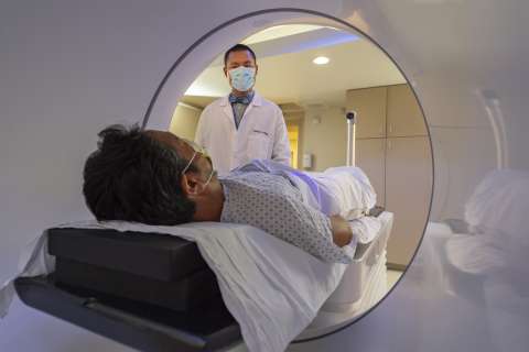 Doctor observing patient during radiation therapy
