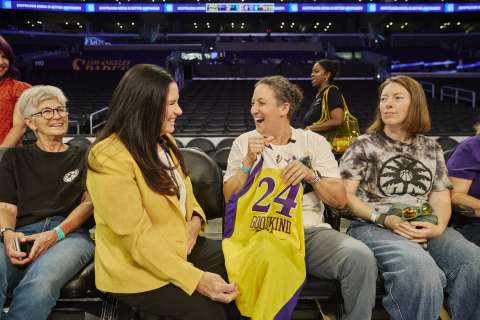 A patient sits courtside at an LA Sparks game with mother, doctor and finacee.
