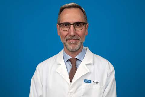 Dr. Antoni Ribas standing in front of a blue background