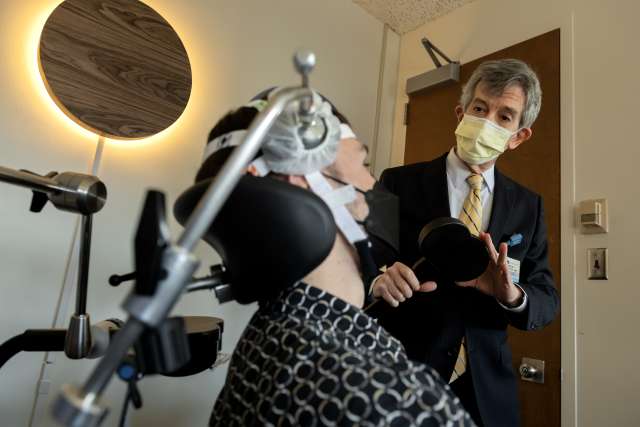 Dr. Andrew Leuchter, director of the Transcranial Magnetic Stimulation program at the Jane and Terry Semel Institute for Neuroscience and Human Behavior, explains how TMS works. (Photo by Joshua Sudock/UCLA Health)