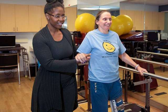 Woman guiding another woman in an exercise studio