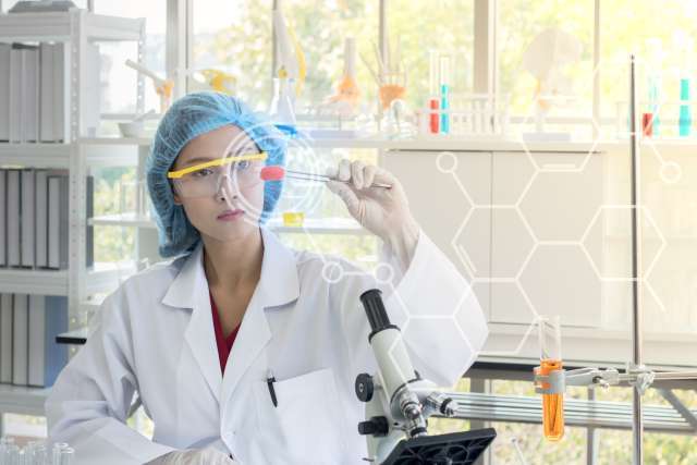 Researcher looking at test tube
