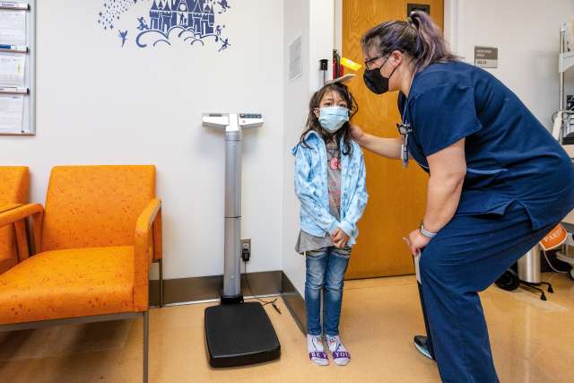 Seven-year-old Leanna is checked in for her triweekly blood transfusion.
