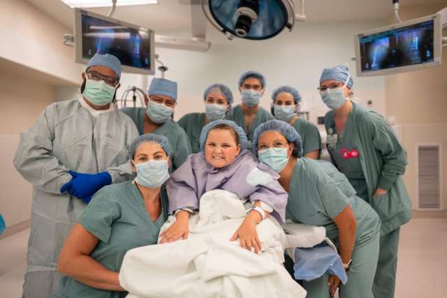 Scarlett Ferguson, center, with Dr. Rachel Thompson to her left and the rest of her surgical team.