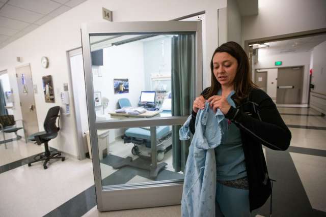 Karleen Wray holding a patient gown