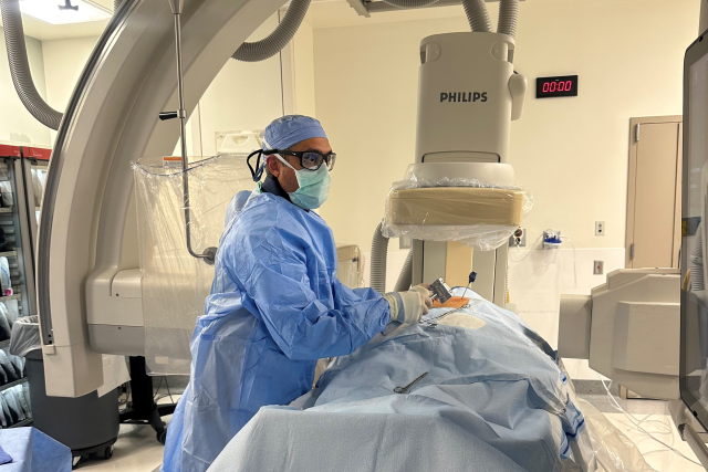 Dr. Jay Acharya in the operating room, performing a procedure on a patient