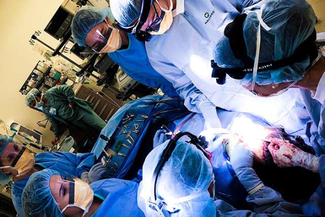 Doctors performing facial feminization surgery
