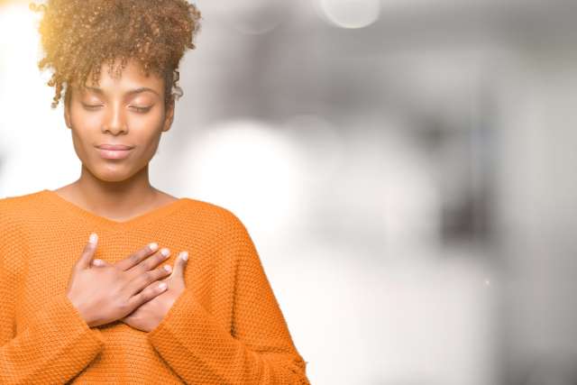 woman holding her heart