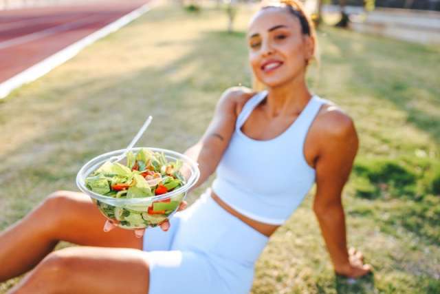 Woman with plant-based snack after workout