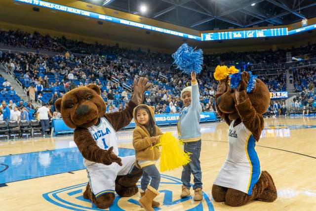 Myla and Rainen Valeriano join Joe and Josie Bruin in the basketball court at Pauley Pavilion. (Photo by Catherine Boyer/UCLA Health)